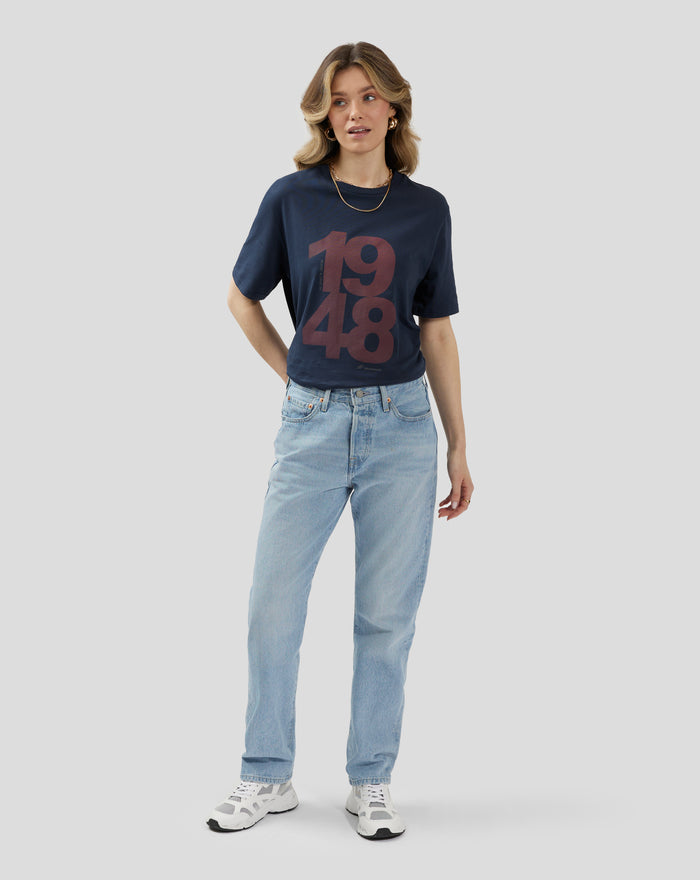 Female model wearing navy Unisex Silverstone Core 1948 T shirt with large burgundy front graphic