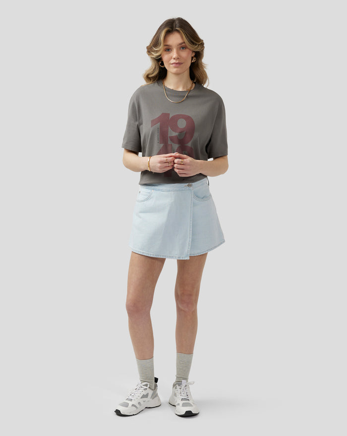Female model wearing charcoal Silverstone Core 1948 T Shirt with bold center front print