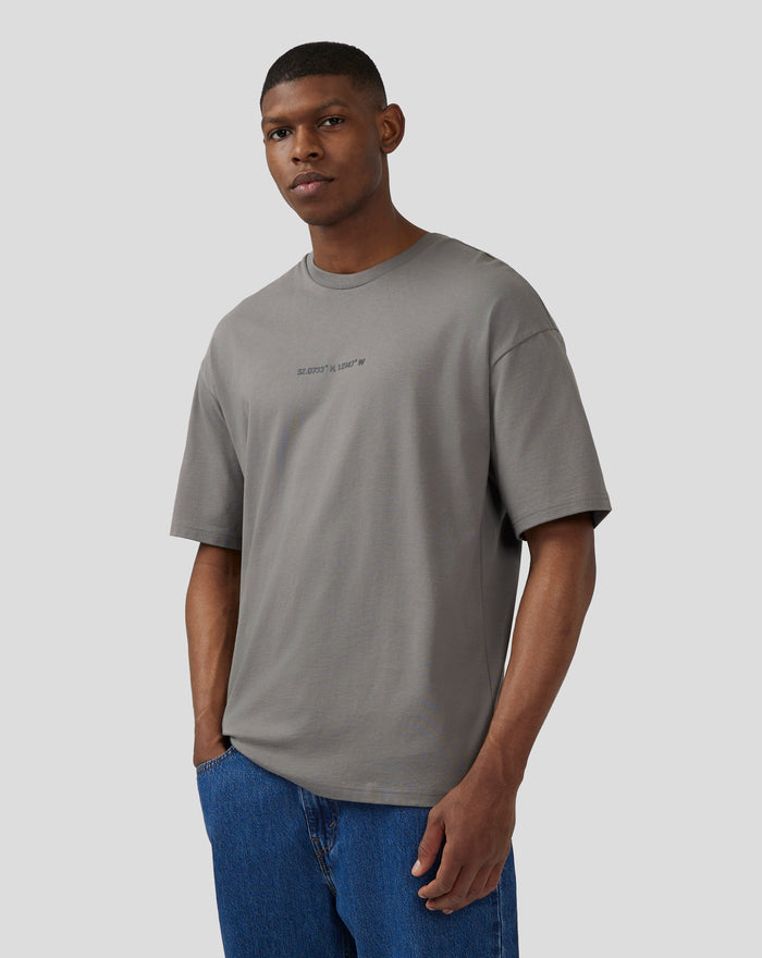 Front view of a model wearing the Unisex Silverstone Core Oversized T-Shirt in charcoal grey.