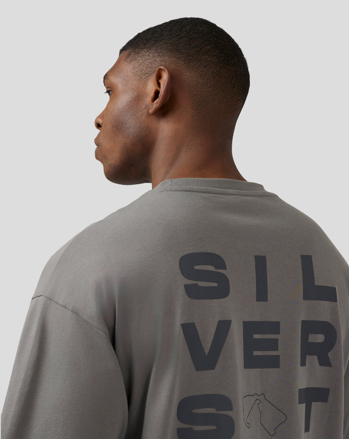 Side profile of a man wearing charcoal grey Silverstone Core Oversized T Shirt showcasing the relaxed fit