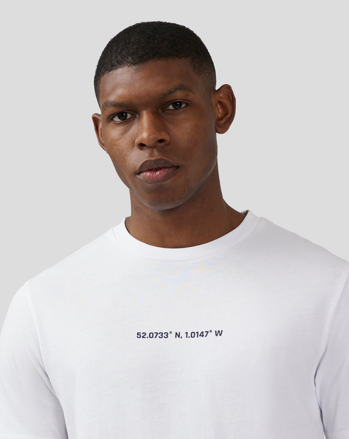 Front view of white unisex T shirt with coordinates printed across the chest