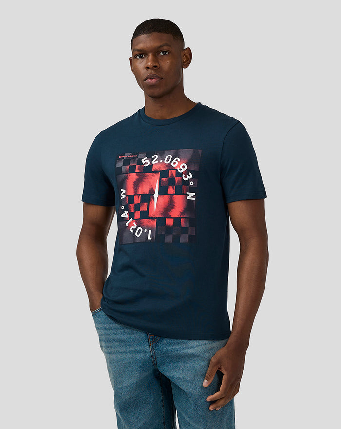 Male model wearing Unisex Silverstone x Castore Coordinate Graphic T-Shirt in Black Iris with a bold red and white geometric chest graphic.
