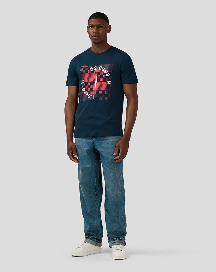 Male model wearing Unisex Silverstone x Castore Coordinate Graphic T-Shirt in Black Iris with red and black geometric print