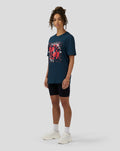 Female model wearing Unisex Silverstone x Castore Coordinate Graphic T-Shirt in Black Iris with oversized relaxed fit and red geometric print