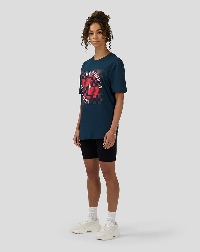 Female model wearing Unisex Silverstone x Castore Coordinate Graphic T-Shirt in Black Iris with oversized relaxed fit and red geometric print